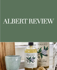 Koala Eco products beside a green mug on a wooden surface.