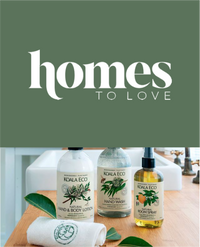 Koala Eco products on a wooden counter with green leaves.