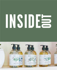 Four Koala Eco hand wash bottles with botanical labels on a shelf.