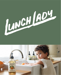 Child at a kitchen sink with a Koala Eco hand wash bottle.