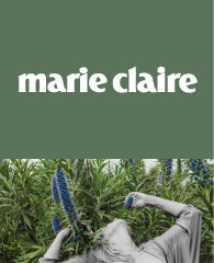 Marie Claire cover with a person in a garden against a green background.