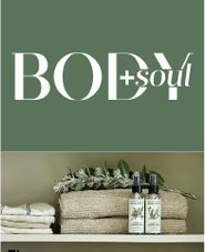Koala Eco products with towels and greenery on a shelf.